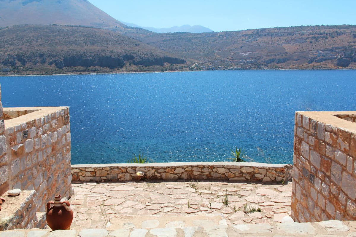 Stone terrace at Selana Studios looking out over Oitylo bay
